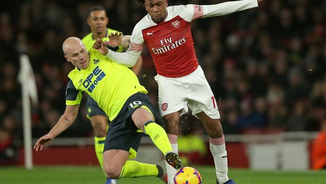 Aaron Mooy, left, vies with Arsenal's Nigerian striker Alex Iwobi while playing for Huddersfield Town. Picture: AFP