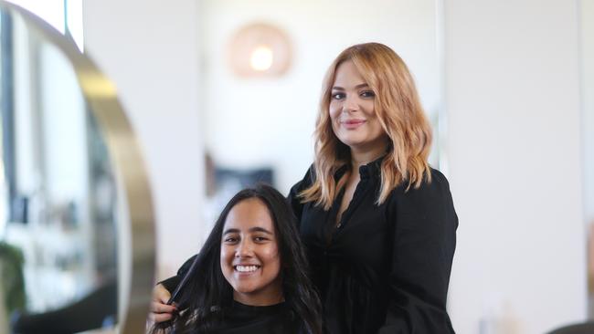 Amie Simm curls Sheena McQueen's hair. Picture: Brendan Radke