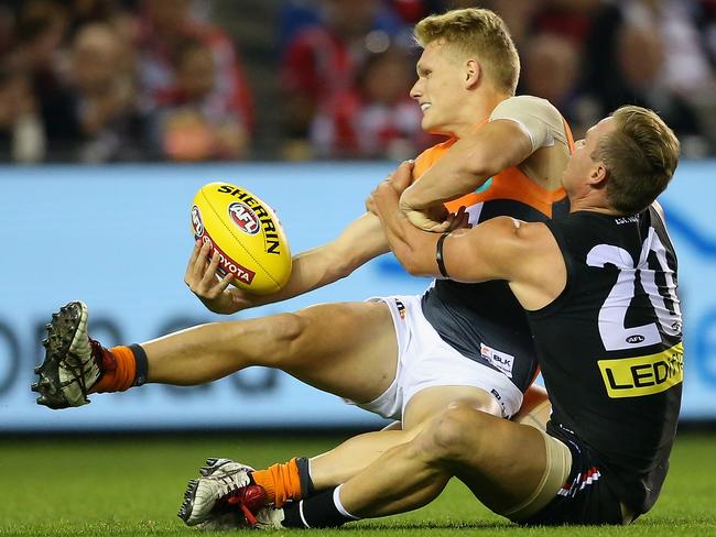 Adam Treloar is tackled by St Kilda’s David Armitage.