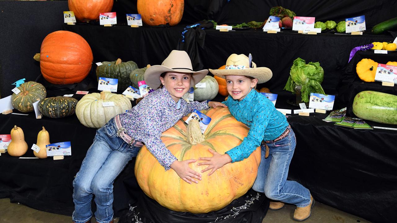 Isla Martin (9) and her sister Lacey Martin (6) and the grand champion pumpkin at the show. Heritage Bank Toowoomba Royal Show. Saturday March 26, 2022