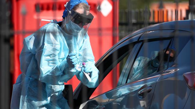 A nurse tests people for COVID-19 in Auckland, New Zealand after new virus cases emerged. Picture: Fiona Goodall/Getty Images