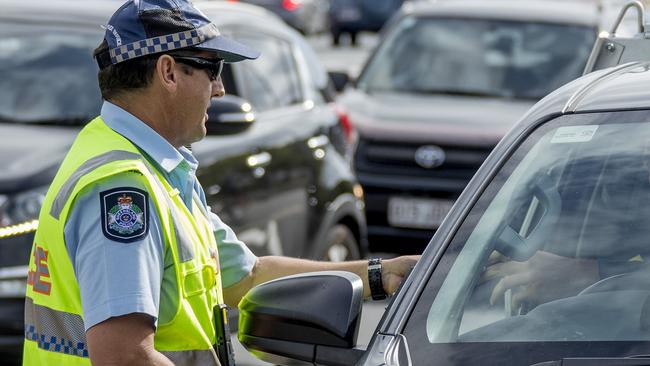 Police officers from the Road Policing Command conducting a road-safety operation on at Varsity Lakes Primary College school. Picture: Jerad Williams.