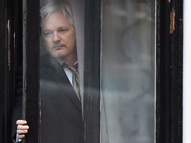 WikiLeaks founder Julian Assange coming out on the balcony of the Ecuadorean embassy to address the media in central London in 2016. Picture: AFP