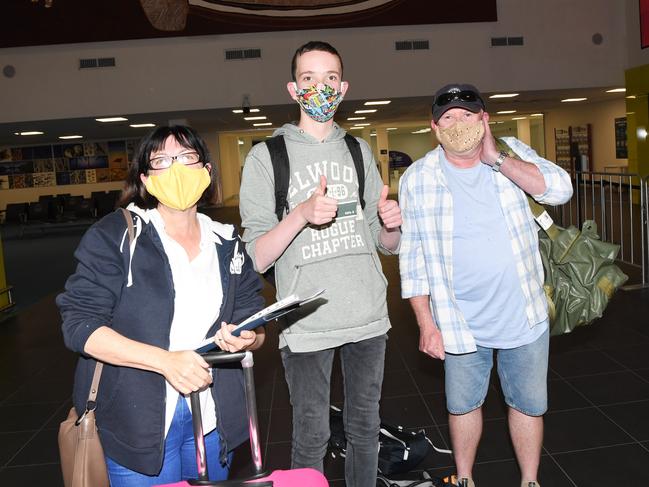 Sydney Flight QF840 arrive in Darwin April Tinker, OscarTinker and Stuart Tinker are glad they made it through to Darwin from Tasmania without having to quarantine.   Picture Katrina Bridgeford.