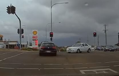 Dash cam footage has captured the moment a driver enters a Toowoomba intersection on a red light. 