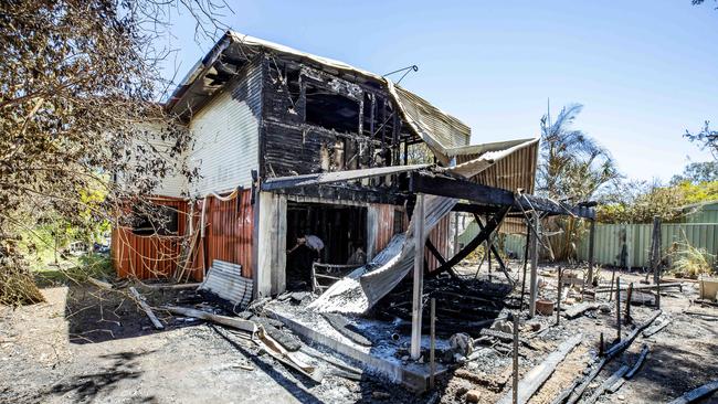 Cleaning up house fire at Catalina Street, Loganlea. PICTURE: Richard Walker