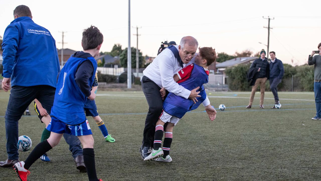 … and forgets which code he’s playing, crash-tackling a child … Picture: Jason Edwards