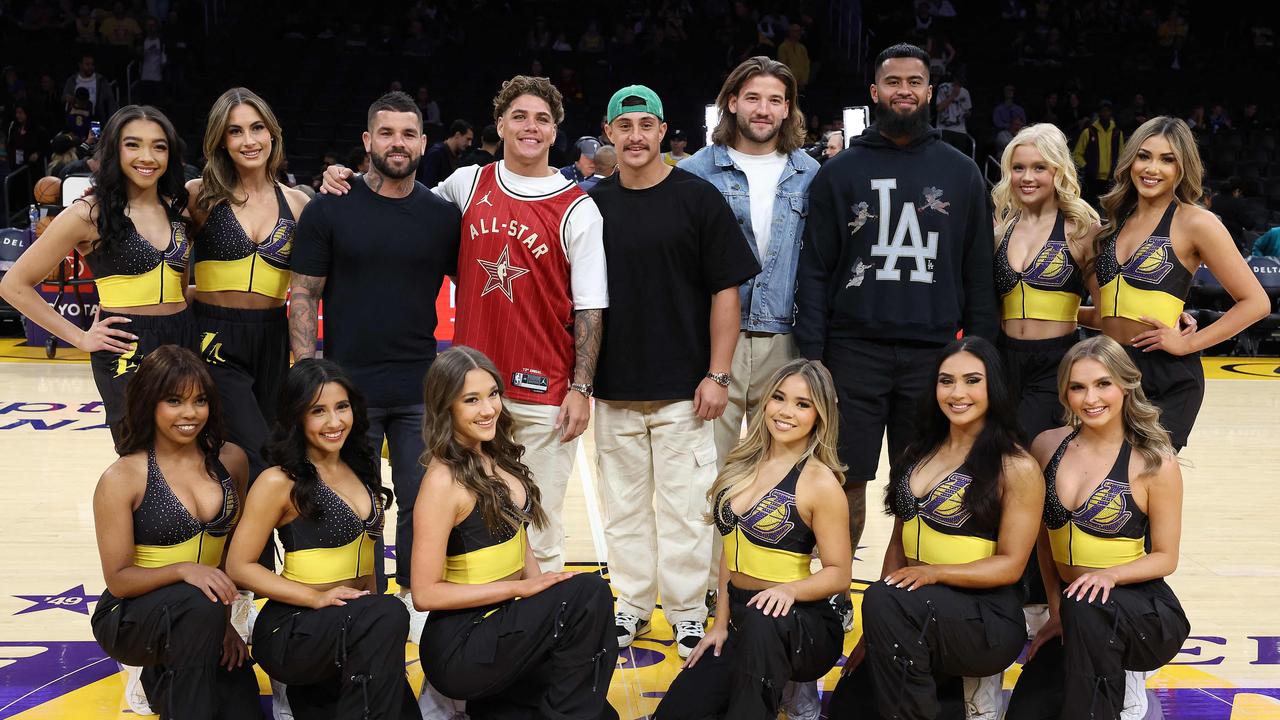 Adam Reynolds, Reece Walsh, Katoni Staggs, Patrick Carrigan, and Payne Haas pose for a photo with the Los Angeles Lakers cheerleaders.