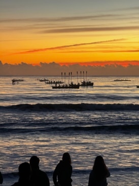 Surf boat crews raise their oars in salute at 2024 Mooloolaba Anzac Day