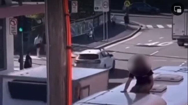 Chilling footage has captured the extremely dangerous moment a man climbed onto the roof of a public bus before it pulled away from a stop.