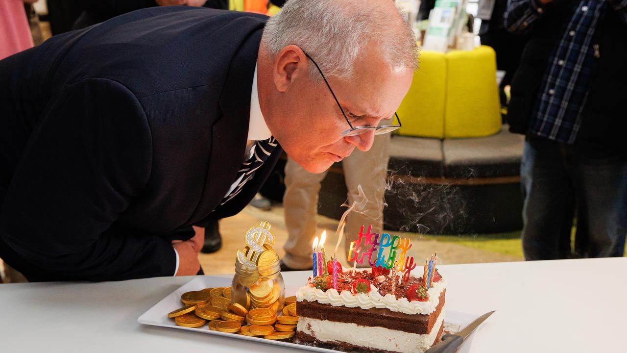 Scott Morrison blows out the candles on a birthday cake at the Beveridge Community Centre in Victoria. Picture: Jason Edwards