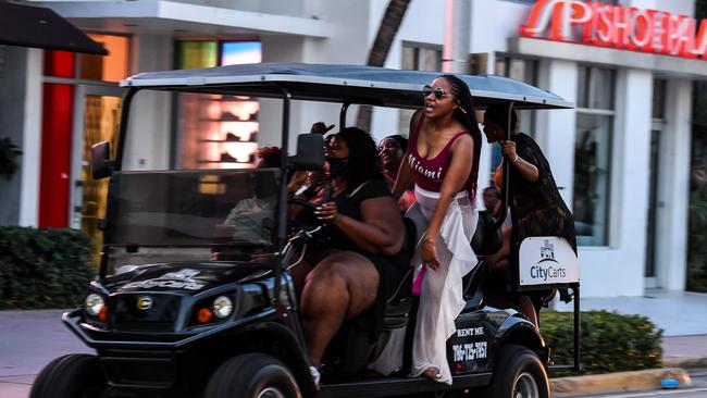 Women sing as they cruise along Miami Beach at the weekend. Picture: AFP