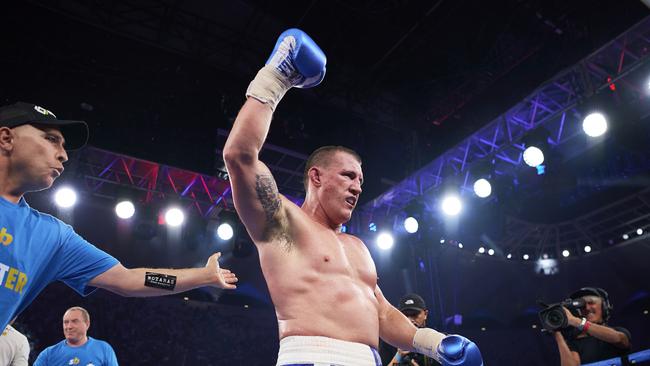 Paul Gallen celebrates his stunning defeat of UFC legend Mark Hunt last December.