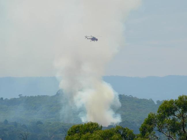 A water bomber battles a bushfire threatening residents in Melbourne’s outer east. Picture: Nicole Bates