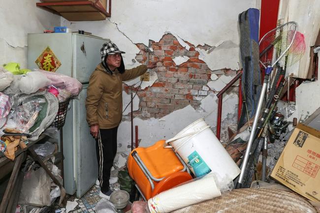 A resident in Tainan shows damage to his home after a 6.0-magnitude earthquake hit Taiwan