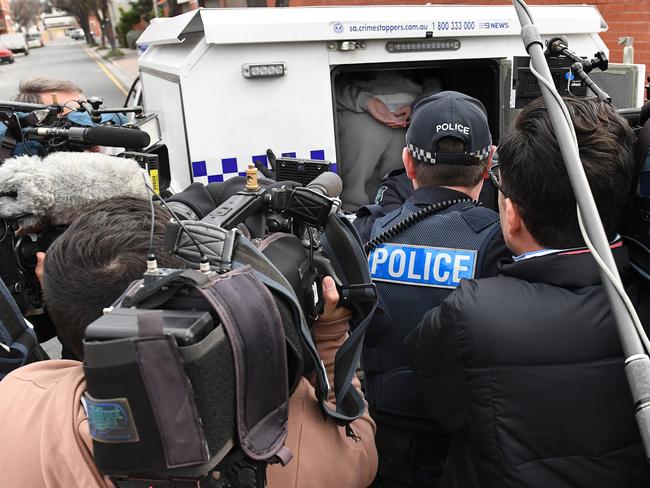 One of the three youths is rearrested by police on the steps of the Adelaide Magistrates Court, in front of shocked family members and the media. Picture: Naomi Jellicoe