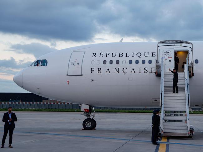 France's President Emmanuel Macron waves as he boards his Presidential aeroplane to travel to New Caledonia in an attempt to resolve a political crisis. Picture: AFP