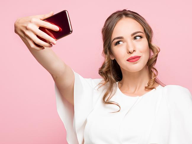 A woman talking a selfie on her smartphone or mobile phone. Picture: iStock.