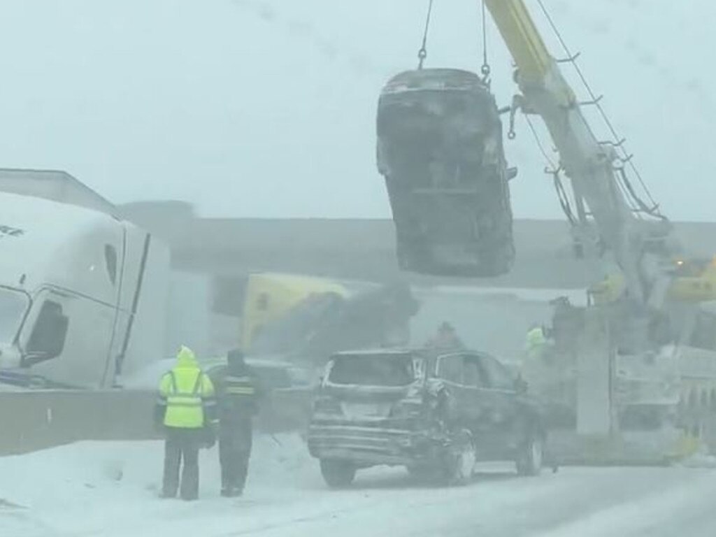 Officials try to clear the mess after the huge crash.