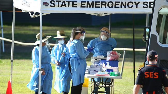 Health workers at a pop-up testing clinic at Indooroopilly State High School in Brisbane on Saturday. Picture: Jono Searle/Getty Images