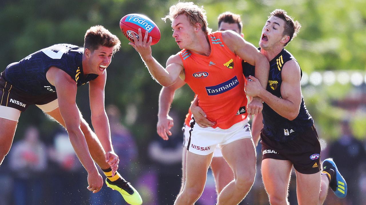 James Worpel withstands a tackle from Daniel Howe and James Cousins.