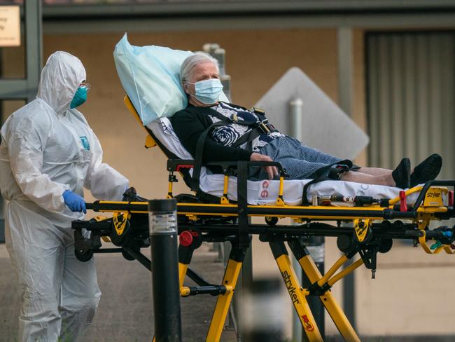 Residents are removed from an aged care centre because of a coronavirus outbreak. Picture: Jason Edwards