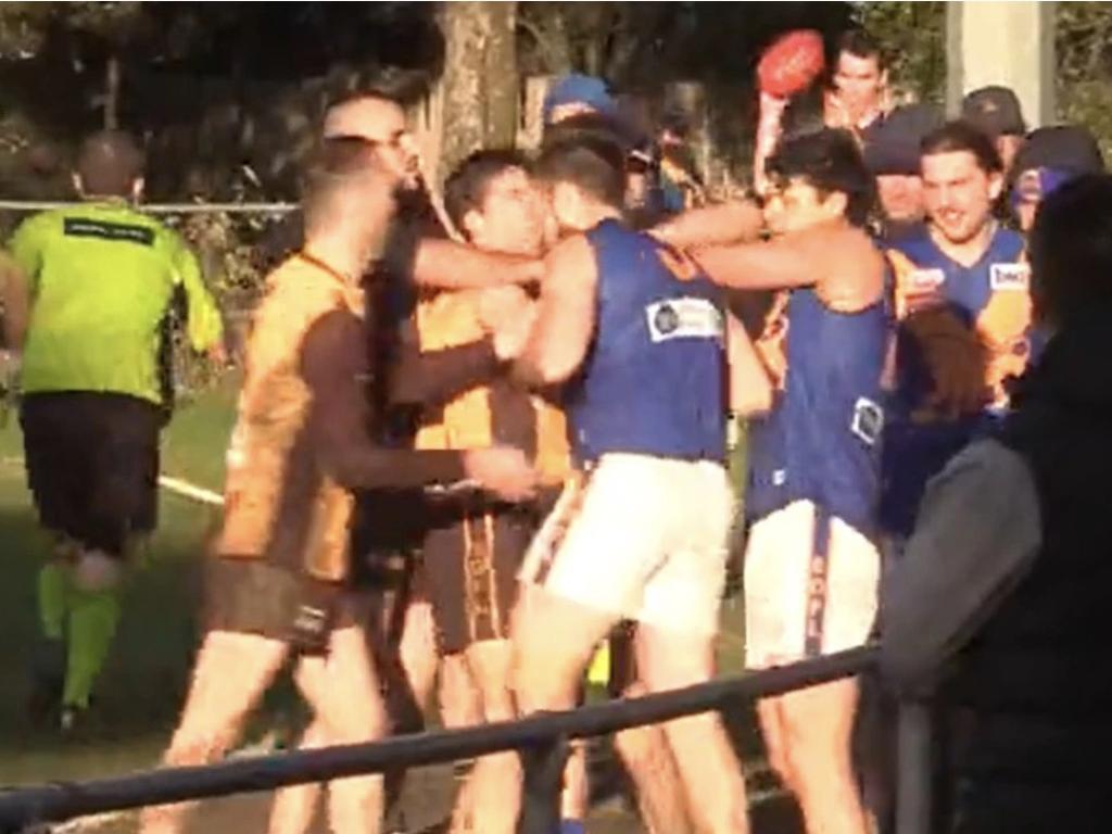 A former AFL official who was involved in the Brownlow Medal betting controversy has endured a violent altercation during a local football match, leaving him battered and bleeding.