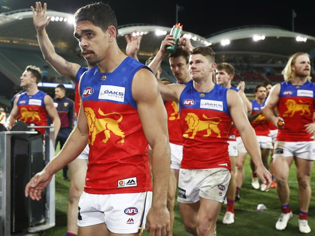 Charlie Cameron leads his team off the field after the Lions won by 48 points.