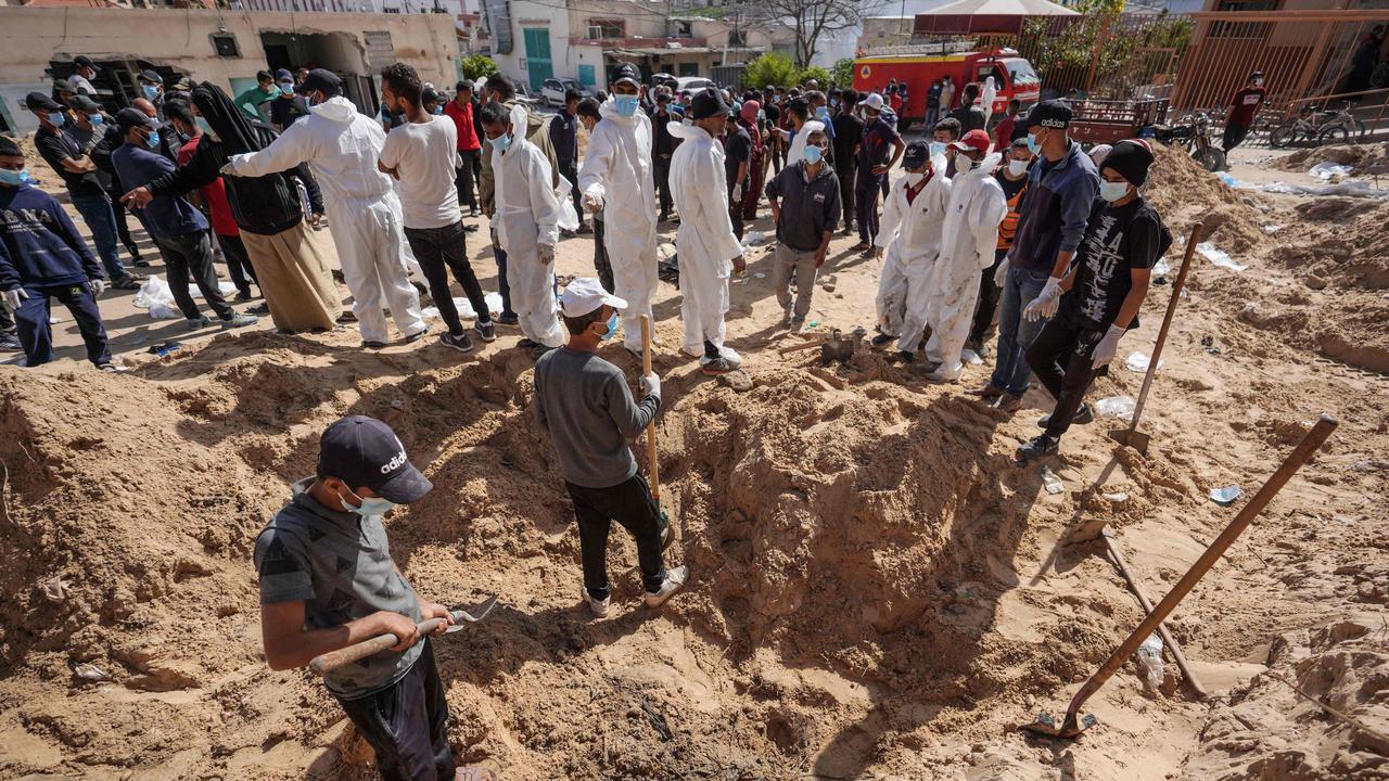 Palestinian health workers dig for bodies buried by Israeli forces in Nasser hospital compound in Khan Yunis in the southern Gaza Strip on April 21, 2024, as battles continue between Hamas militants and Israeli forces in the besieged Palestinian territory. (Photo by AFP)