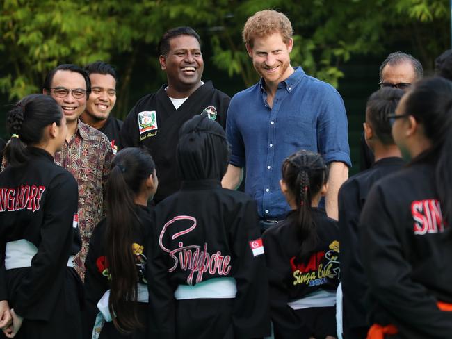 Prince Harry watches a martial arts demonstration at Jamiyah Singapore. Picture: Chris Jackson/Getty Images