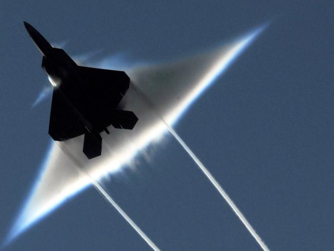 FILE - This June 22, 2009 photo released by the U.S. Navy shows an Air Force F-22 Raptor executing a supersonic flyby over the flight deck of the aircraft carrier USS John C. Stennis in the Gulf of Alaska. The Senate voted Tuesday to halt production of the Air Force's missile-eluding F-22 Raptor fighter jets in a high-stakes, veto-laden showdown over President Barack Obama's efforts to shift defense spending to a next generation of smaller, single-engine F-35 Joint Strike Fighters. (AP Photo/US Navy - Ronald Dejarnett, File)