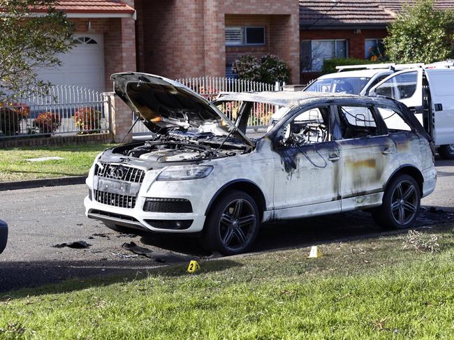 A burnt-out Audi believed to be used linked to a double murder. Picture: Richard Dobson