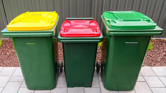 Top view of Australian garbage wheelie bins for recycling, general and green waste.