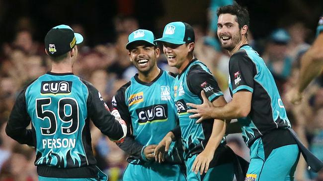 Mitch Swepson (second right) celebrates with team mates Shadab Khan (left) and Ben Cutting (right) after taking a catch.