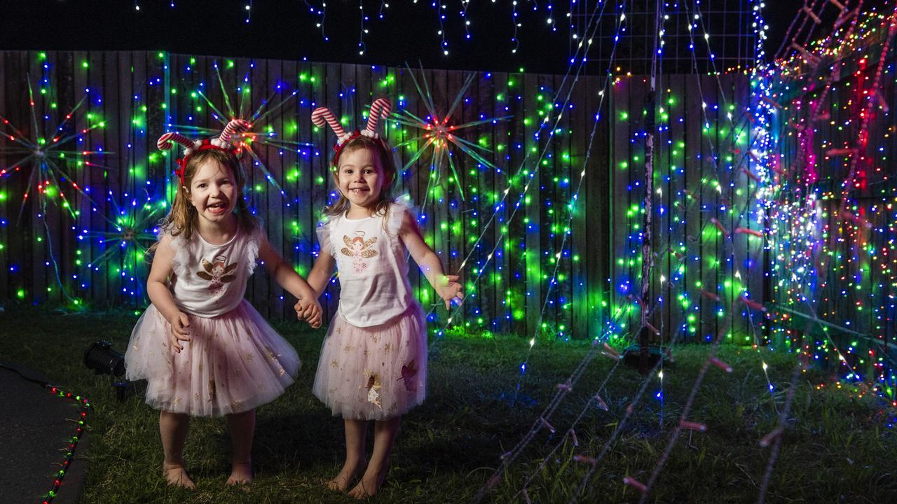 Sisters Ottilie (left) and Everly Rasmussen with the Christmas light display at their family home in Wyreema, Monday, December 13, 2021. Picture: Kevin Farmer