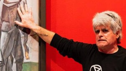 Extinction Rebellion protester Tony Gleeson glued himself to a painting at NGV. Picture: 3AW