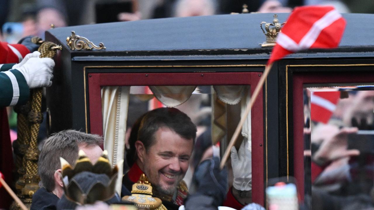 King Frederik X of Denmark reacts as he rides in a carriage with Queen Mary of Denmark escorted by the Guard Hussar Regiment's Mounted Squadron from Christiansborg Palace to Amalienborg in Copenhagen, Denmark. Picture:AFP