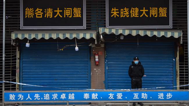 A security guard stands outside the Huanan Seafood Wholesale Market in Wuhan in January. Picture: AFP