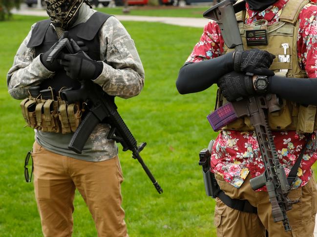 Armed protesters provide security as demonstrators take part in an "American Patriot Rally," on the steps of the Michigan State Capitol this year. Picture: AFP