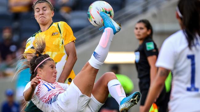 Steph Catley (left) of the Matildas reacts as Yanara Aedo of Chile kicks the ball during the Womens International Friendlies soccer match between the Matildas and Chile at Bankwest Stadium in Sydney, Saturday, November 9, 2019. (AAP Image/David Gray) NO ARCHIVING, EDITORIAL USE ONLY