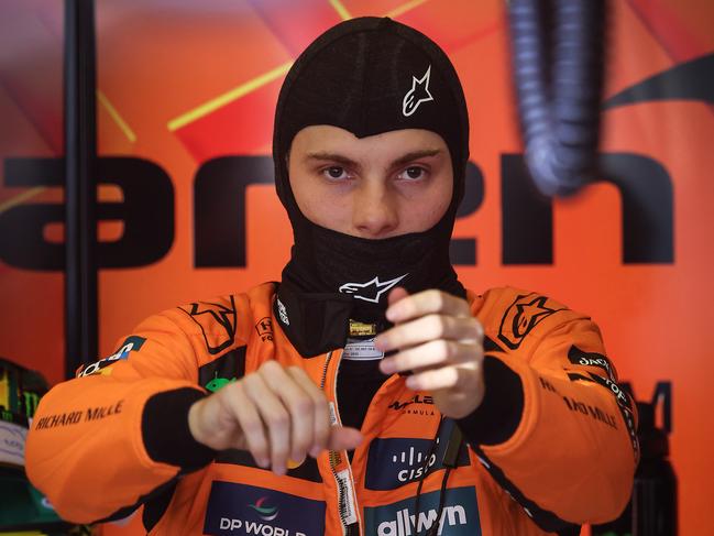 McLaren driver Oscar Piastri puts on his safety gear and helmet before heading out on the track. Picture: David Caird