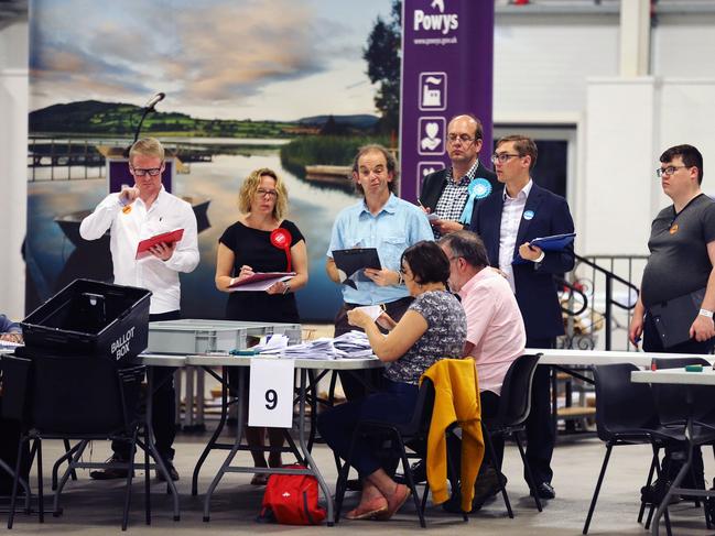 Ballot papers are counted during the Brecon and Radnorshire by-election count at the Royal Welsh Showground in Builth Wells, Wales on August 2, 2019. - Britain's Boris Johnson faces his first test at the ballot box Thursday in a by-election that could reduce his parliamentary majority to just one, as his new government vowed to double funding for a possible no-deal Brexit. Johnson's Brexit plan could also become harder to enact as his governing Conservative Party looks set to lose the Welsh seat of Brecon and Radnorshire to a pro-Europe candidate on Thursday. (Photo by Isabel INFANTES / Isabel Infantes/AFP/Getty Images / AFP)