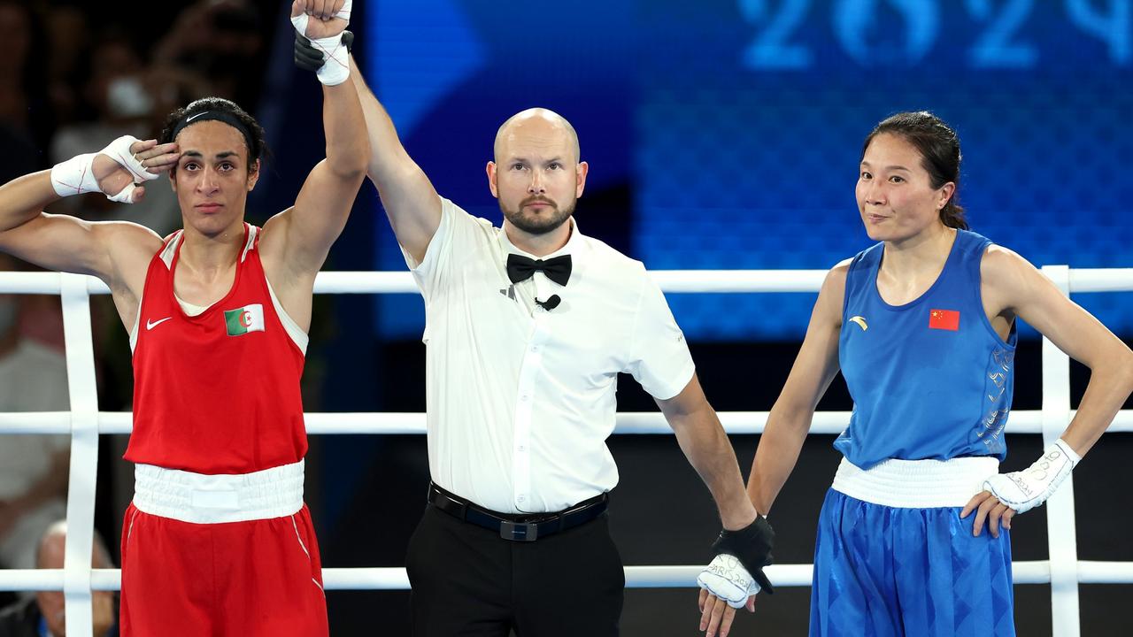 Liu Yang of Team China looks on as Match Referee Jakov Peterson raises the hand of Imane Khelif of Team Algeria. Photo by Maja Hitij/Getty Images