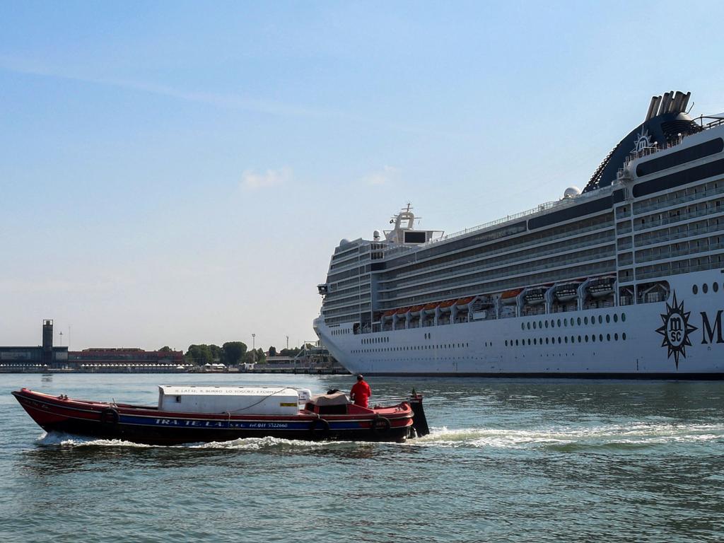 The MSC Orchestra cruise ship docks at the Santa Chiara maritime port in Venice, Italy, after arriving on June 03, 2021. - Before the coronavirus pandemic brought the industry to a halt, cruise ship traffic boomed in Venice, bringing millions of extra visitors to the UNESCO World Heritage city.  But to critics, giant tourist vessels were an eyesore and potential safety hazard, passing exceptionally close to Venice's historic buildings, as well as a threat to the fragile ecosystem of its lagoon. (Photo by ANDREA PATTARO / AFP)
