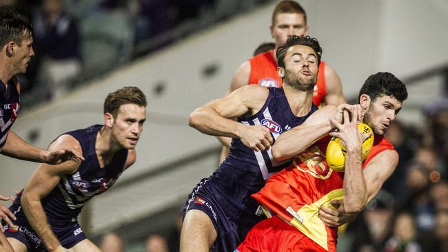 Jarrad Grant of the Gold Coast Suns takes a mark against the Fremantle Dockers in 2017. (AAP Image/Tony McDonough)