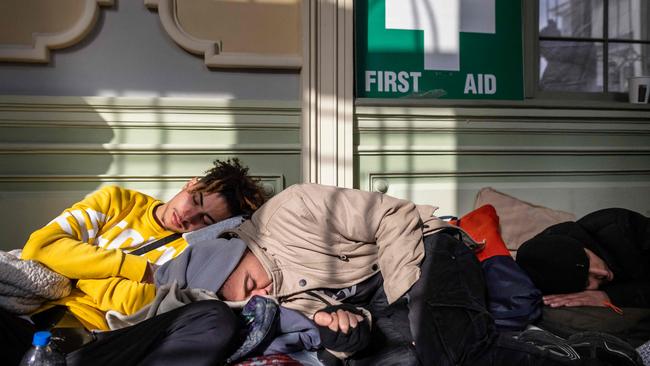 Refugees from Ukraine are seen resting in temporary reception point organised in the main railway station in Przemysl, in eastern Poland. Picture: AFP