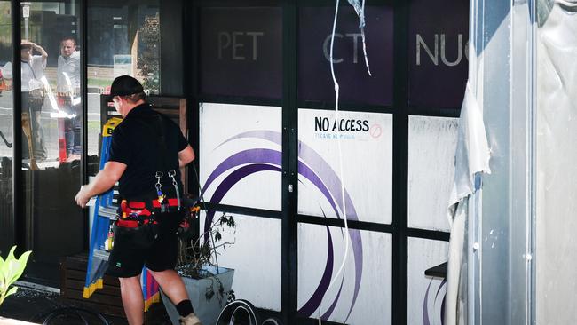 Workmen start assessing the damage from a fire overnight at a cafe on the front of the Pacific Private Hospital on Nerang Street Southport. Picture Glenn Hampson