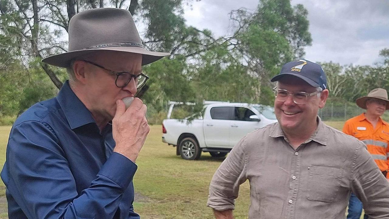 Prime Minister Anthony Albanese, visiting Queensland on Wednesday, tries locally grown lychees with Senator Murray Watt. Photo: Kentos Komms