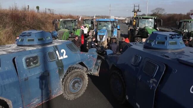 Armored police block French farmers on highway to Paris