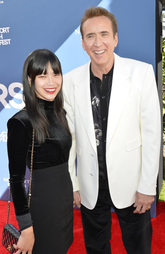 Nicolas Cage, 60, seen smiling on the red carpet with his wife Riko Shibata, 28.